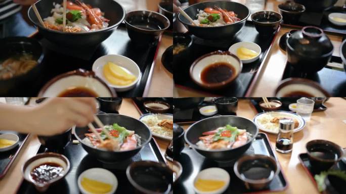 在日本，一群人正在吃三文鱼和金枪鱼配味噌汤