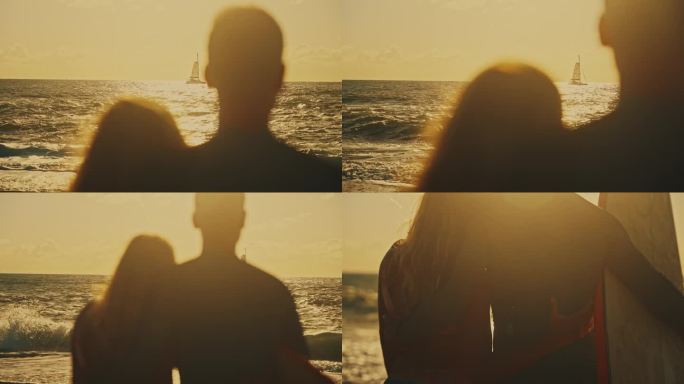 冲浪夫妇带着冲浪板在日落的海洋上看帆船