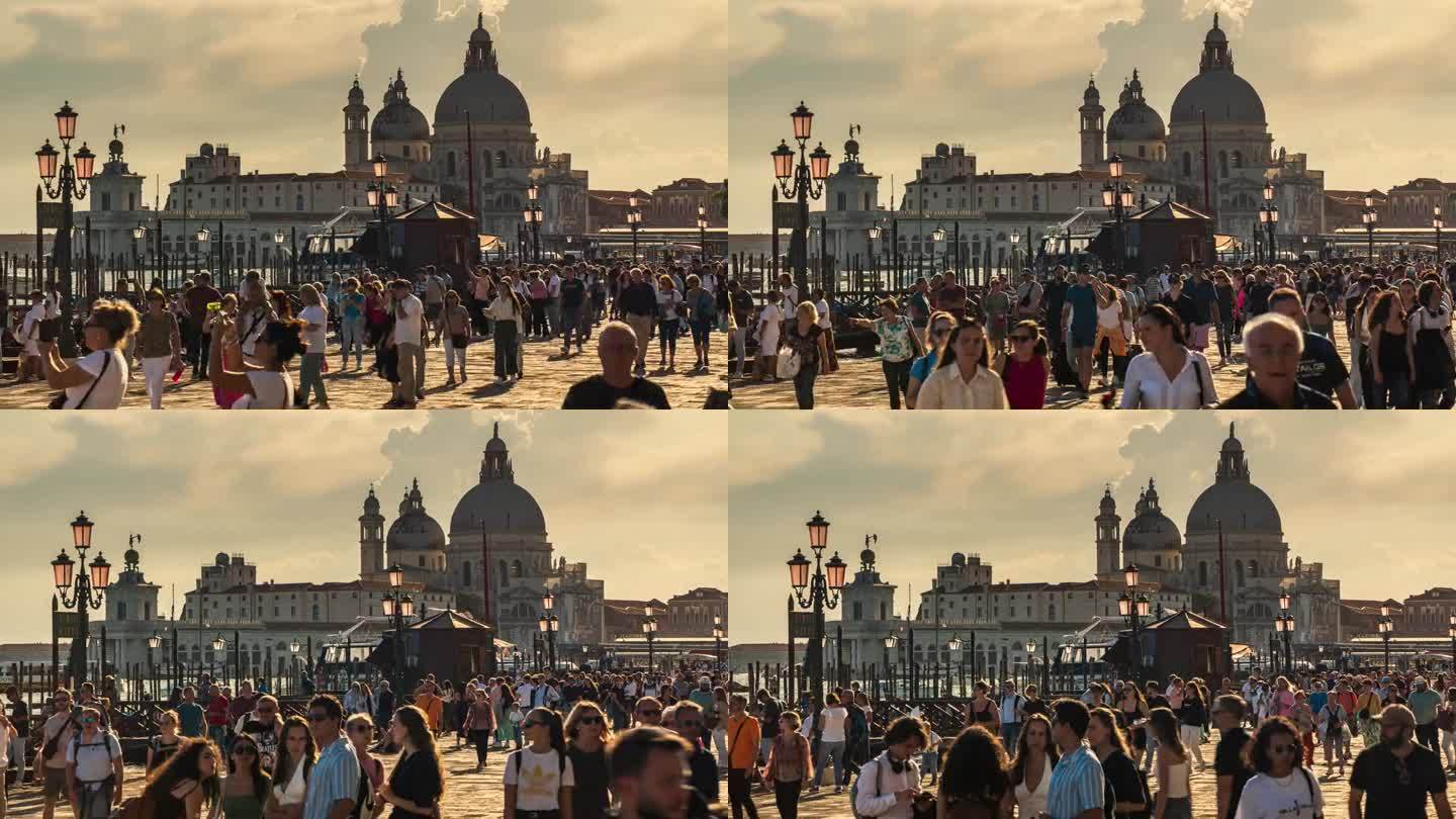 在阳光明媚的意大利威尼斯，拥挤的游客在圣玛丽亚德拉致敬广场散步和购物