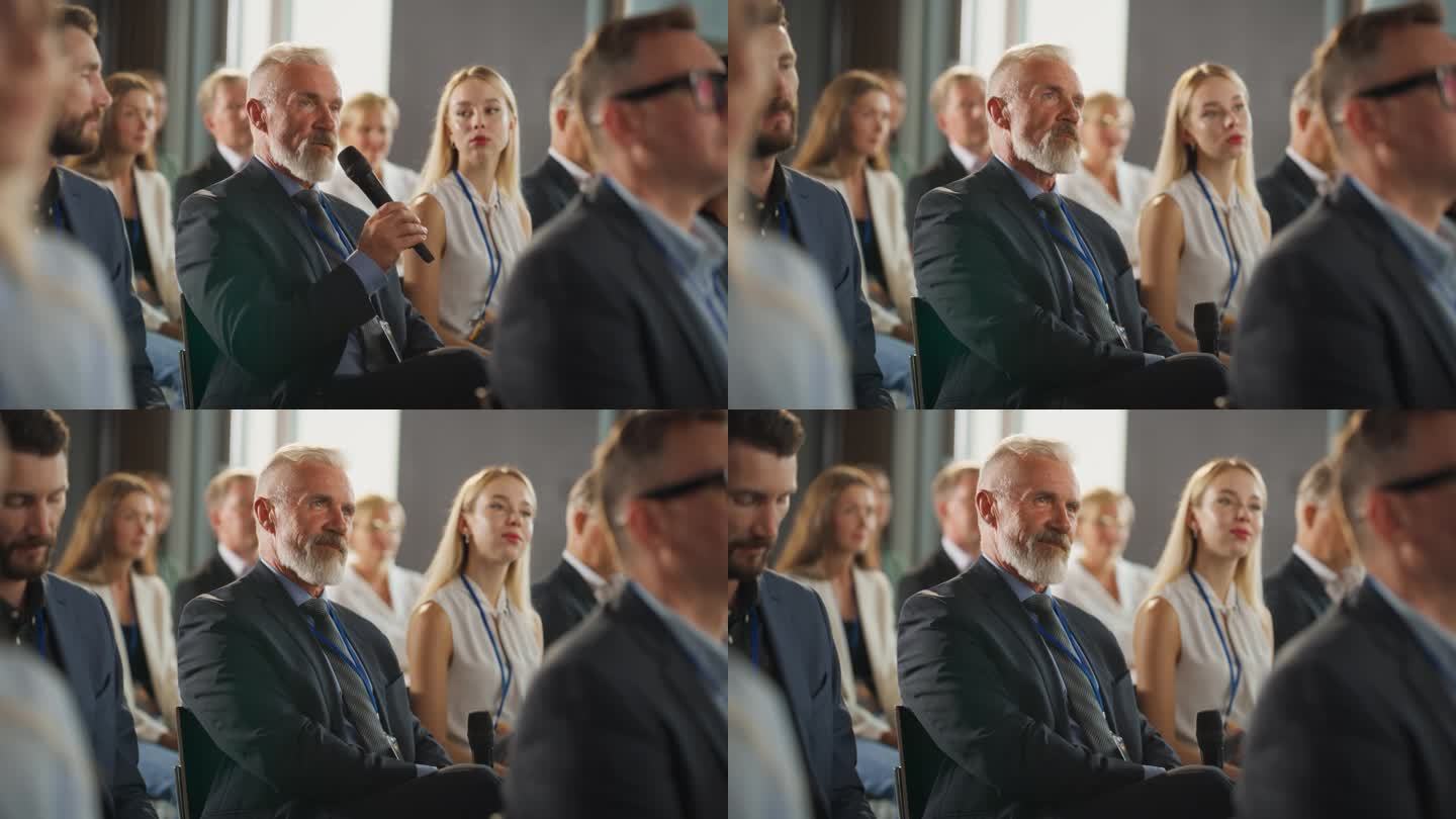 在国际科技会议上，资深男性投资者坐在人群中，用麦克风提问。一名白人男子正在听关于新公司服务的主题演讲