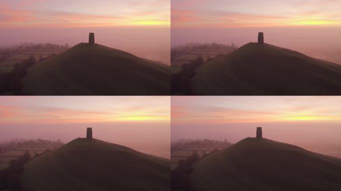 英国萨默塞特郡，格拉斯顿伯里托尔的日出鸟瞰图，色彩缤纷的天空以乡村为背景，人们可以从托尔上看到