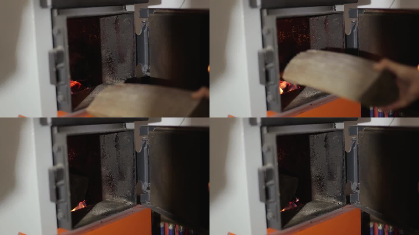 用固体燃料锅炉给房子供暖。木头在大锅的炉子里燃烧