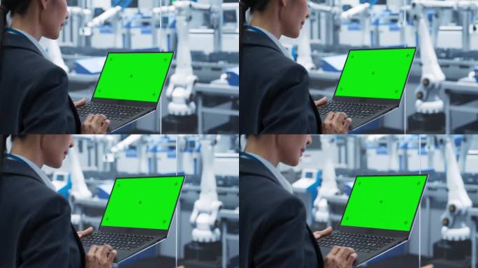 亚洲女工程师使用绿屏模拟显示的笔记本电脑。一位年轻的妇女在工厂里用现代电子机器监督生产。过肩投篮