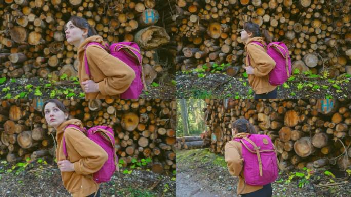女人在秋天的森林里以木桩为背景徒步旅行