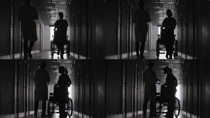 拿着x光片的医生和坐轮椅的护士的剪影