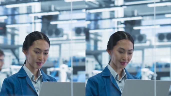 垂直屏幕:电子制造技术人员在组装厂操作笔记本电脑。亚洲女性自动化生产软件开发、维护、设置专家