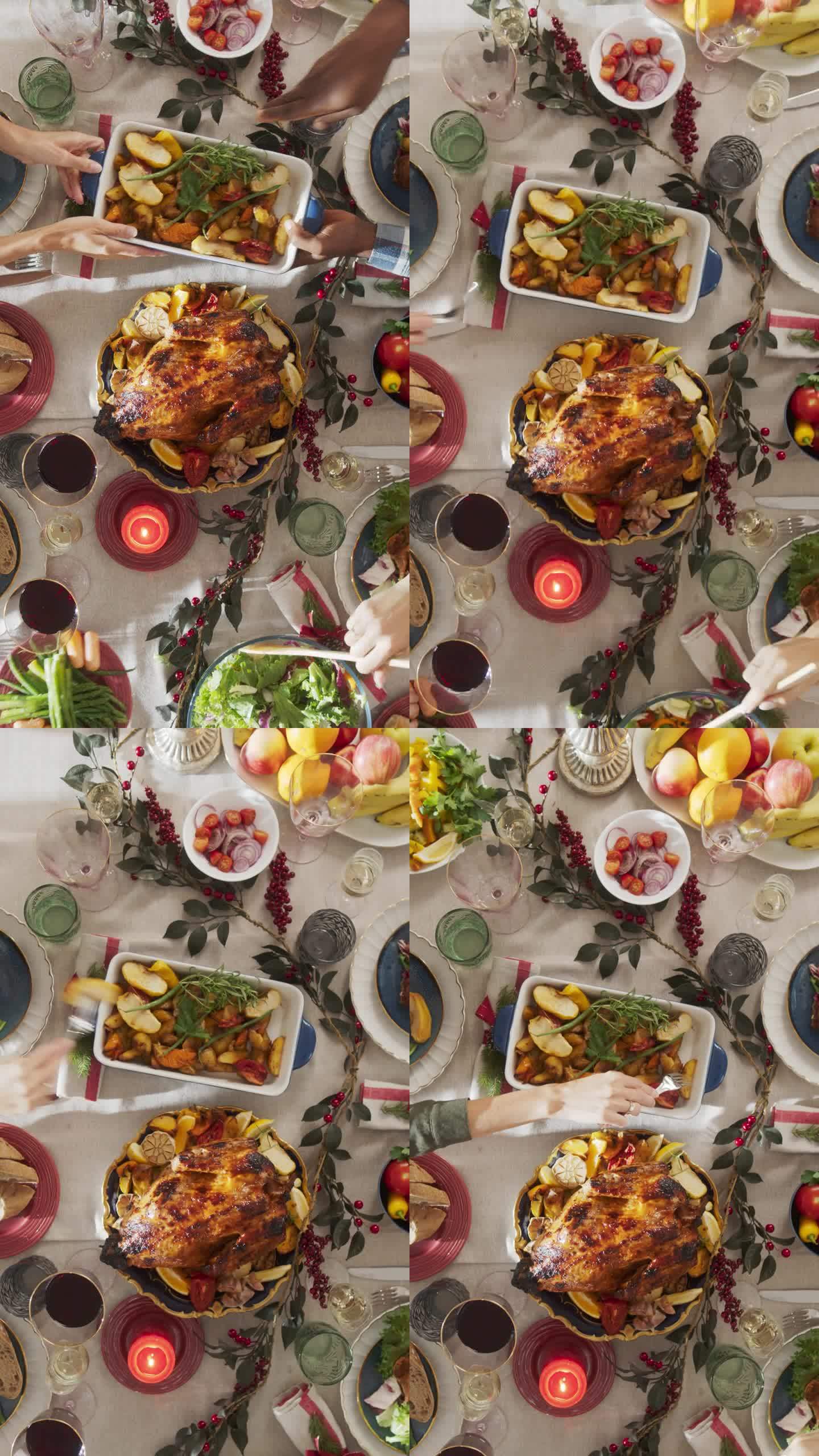 垂直屏幕:餐厅准备圣诞晚餐。不知名的人上菜，把烤火鸡放在餐桌上，装饰着蔓越莓丛和蜡烛。自顶向下镜头