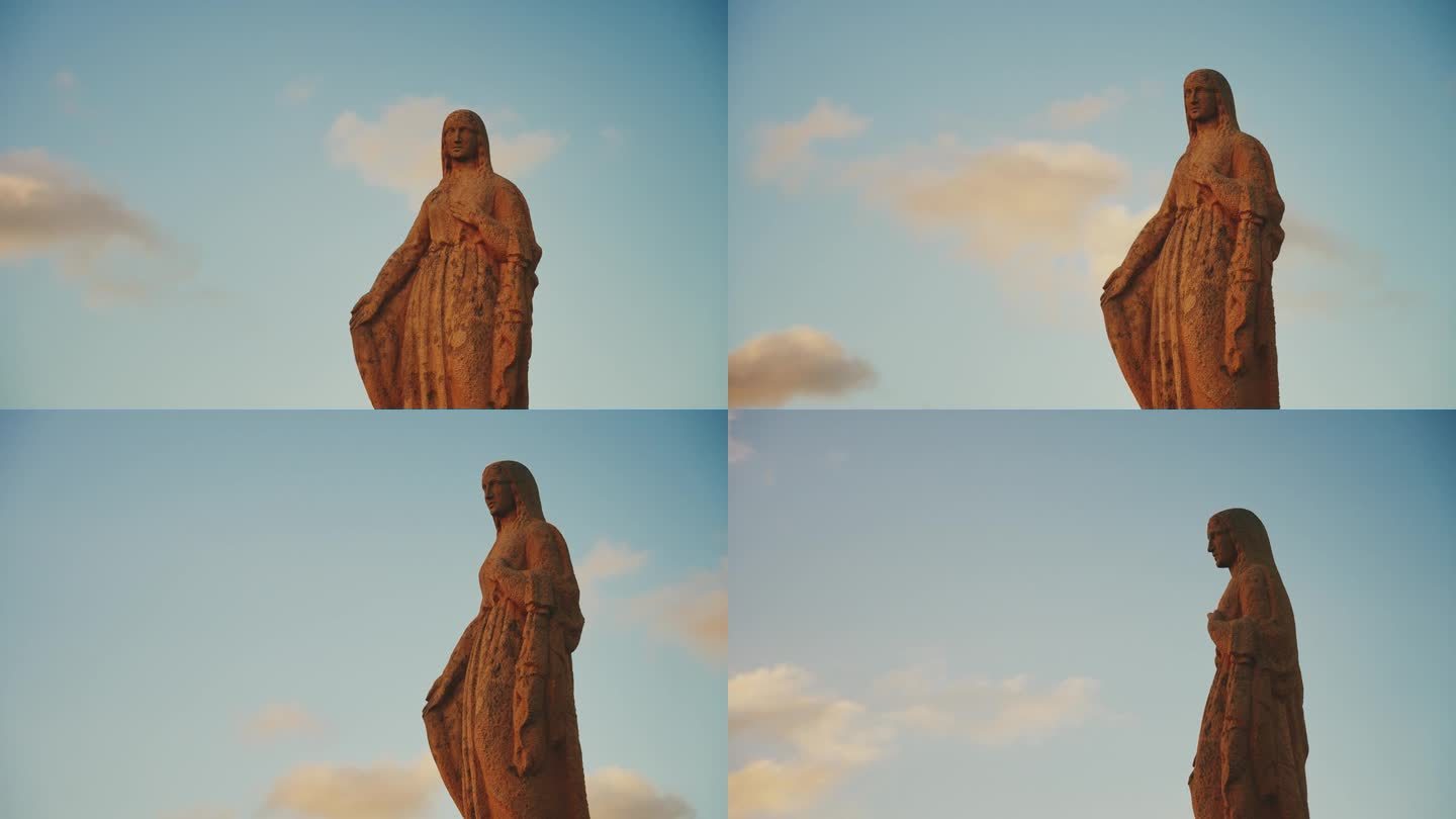 低角度观看圣母玛利亚雕像对着蓝天
