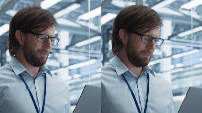 竖屏:一位英俊的工程师戴着眼镜，使用笔记本电脑，环顾着一个工厂设施，那里有为不同行业生产现代电子元件