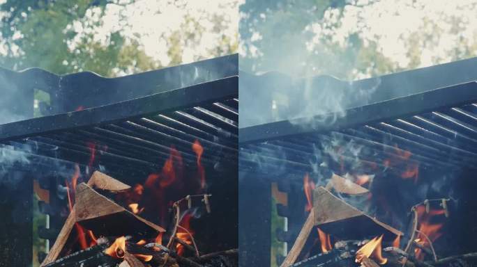 火焰中闷烧的柴火特写。在户外烧烤。垂直视频