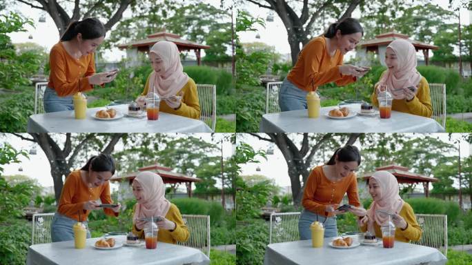 一名年轻的东南亚女子和她的穆斯林朋友在餐厅吃饭时在社交媒体上自拍，向朋友们展示食物。