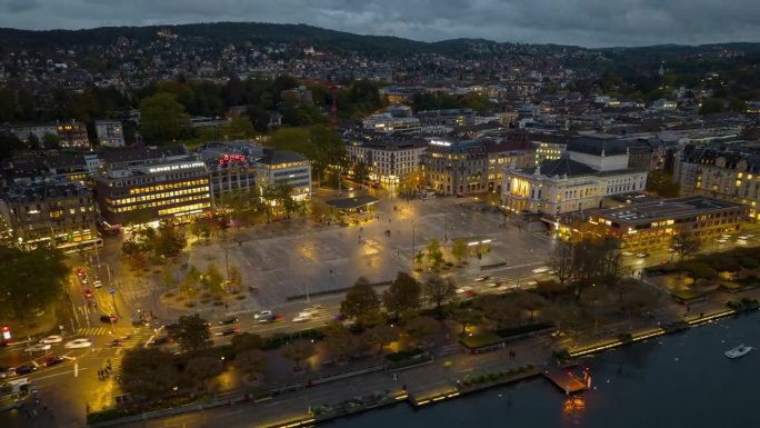 黄昏时分照明苏黎世市中心著名的歌剧院广场湖畔航拍全景延时4k瑞士