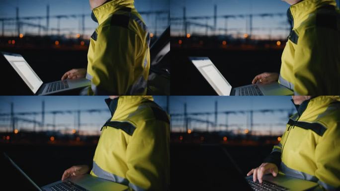成熟的男性工程师在黑暗的发电厂的夜晚用笔记本电脑工作