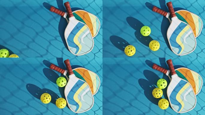 上图为蓝色球场地板上的两个匹克球桨，上面有三个匹克球在滚动