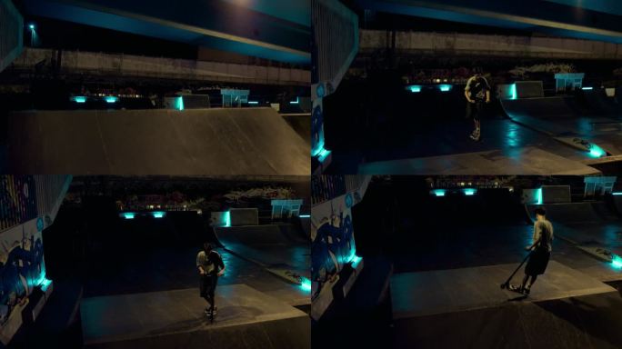 活跃的青少年在夜间滑板公园的坡道上骑滑板车。好动的人在跳。