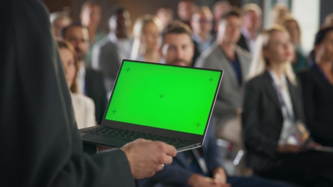 回头看，创业公司CEO手持绿屏Chromakey笔记本电脑，向满屋子的投资者推销产品或服务。在科技论