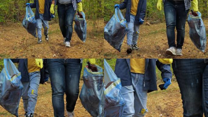 妈妈和儿子自愿拿着垃圾袋在公园周围收集塑料垃圾。生态活动家。这个家庭为拯救和保护自然而斗争。垃圾污染