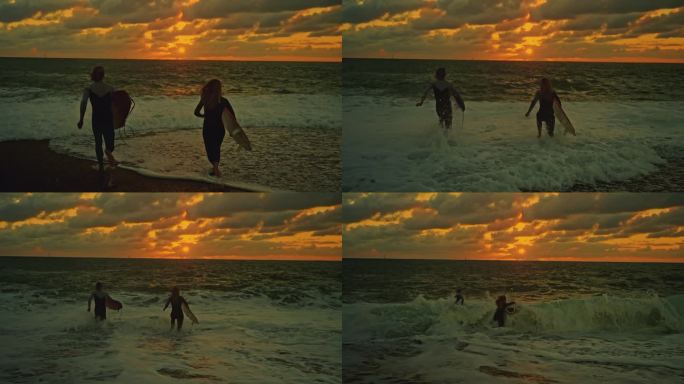 日落时分，一对冲浪夫妇带着冲浪板奔向大海