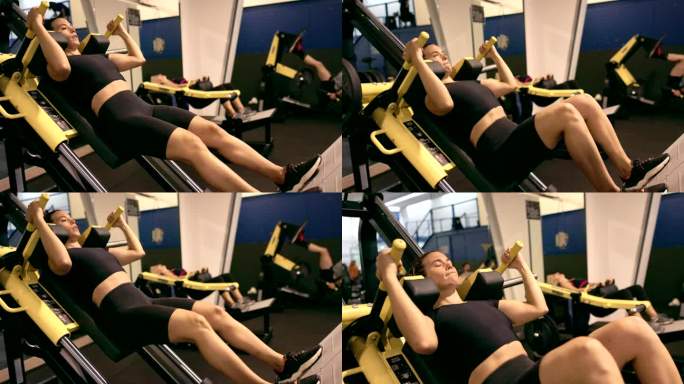 力量训练:女性在腿部按压机上进行腿部运动