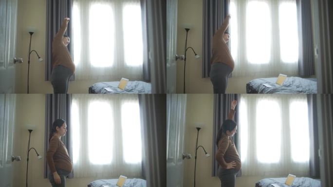亚洲孕妇在卧室里做瑜伽