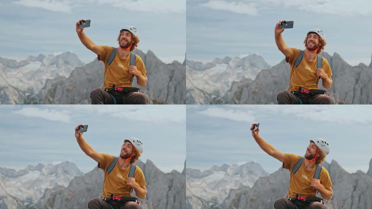 一名男子在登山后在山顶上使用智能手机