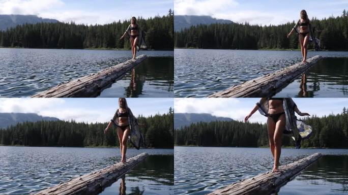 女子划桨板(SUP)穿过宁静的湖泊