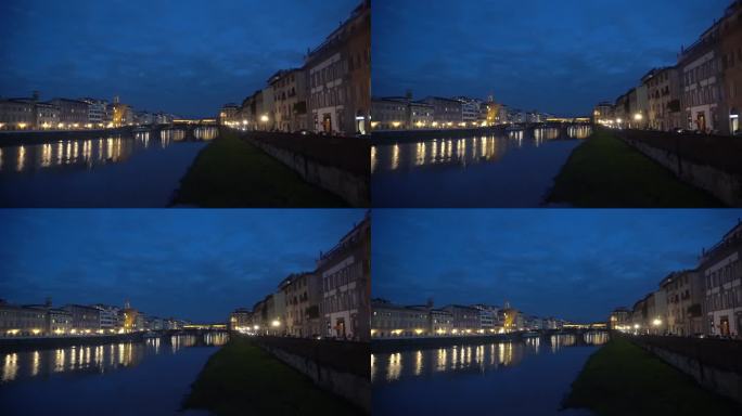 意大利佛罗伦萨，傍晚蓝天与建筑照亮桥在河上美丽的小镇4k