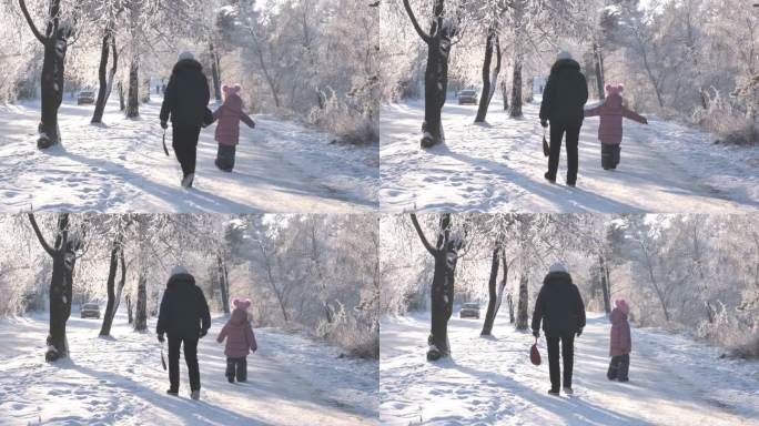冬日里，奶奶带着孙女在雪地里散步。家庭时光快乐。美丽自然