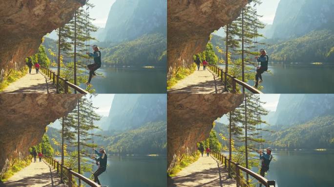 一名男子在奥地利的Gosausee上爬上ferrata，欣赏着美丽的风景