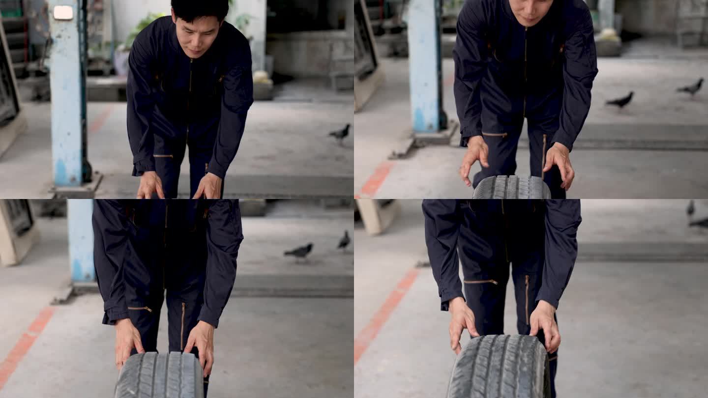 富有魅力的亚洲修理工滚动车轮准备更换损坏的汽车，通过保险检验索赔确认，生活方式多任务修理工或技术人员