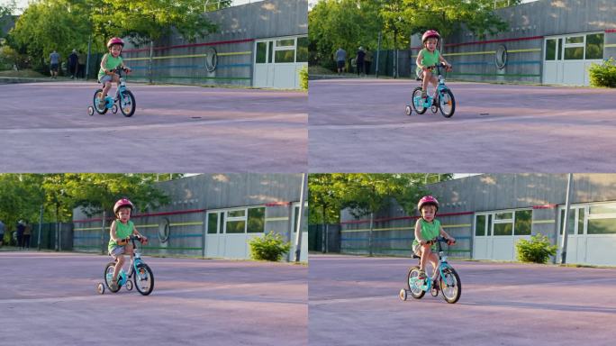 小男孩用学习轮学骑自行车，角度低
