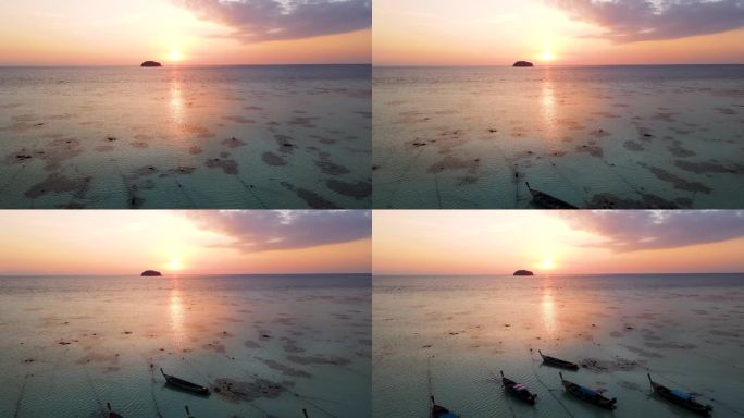 鸟瞰日出与阳光反射和戏剧性的天空与小岛，利比，沙卡通省，泰国