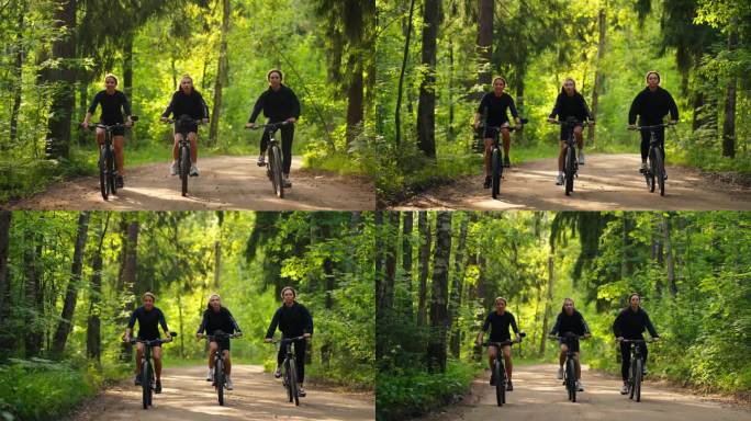 三个年轻女子骑自行车在地面道路上的森林，正面视图，女孩保持健康