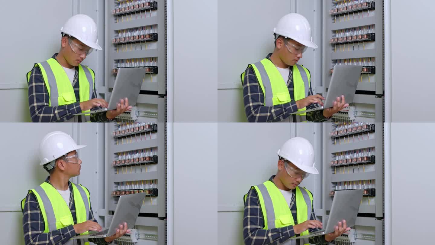 电气工程师在控制室工作。电气工程师在控制室检查配电柜。电力和电气维修服务。
