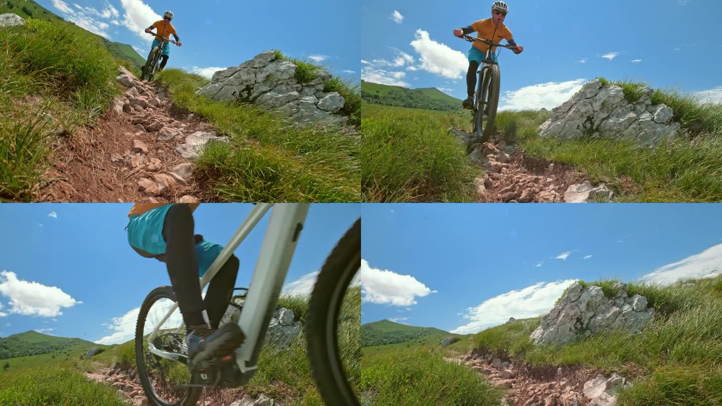 男山地自行车手骑着他的自行车沿着一条多岩石的小路