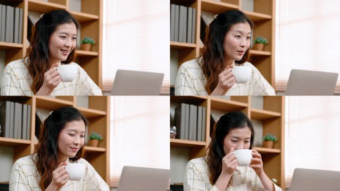 亚洲女性在笔记本电脑上工作，放在办公室的桌子上，因为困了，工作时带了咖啡饮料解困，喝咖啡时变得更加清