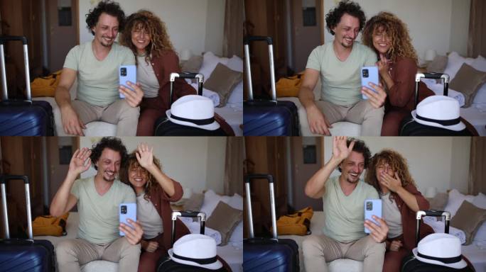 一对恩爱的夫妇在酒店房间里和他们的朋友进行视频通话，玩得很开心
