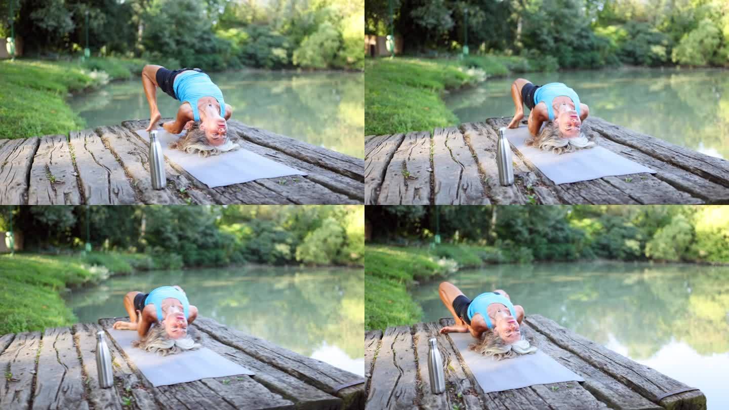 资深女士在湖边练习瑜伽