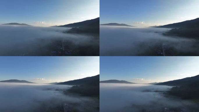 云雾缭绕下的山脚下的村庄