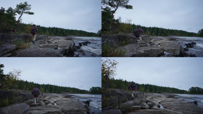 在挪威徒步旅行，游客背着背包独自走在松树林附近美丽的湖边