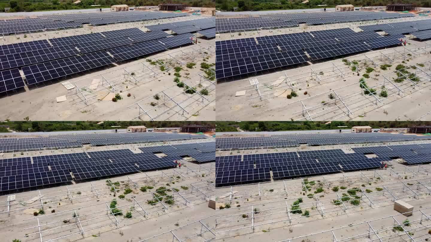 撒哈拉以南非洲太阳能农场鸟瞰图，技术人员正在安装光伏模块面板