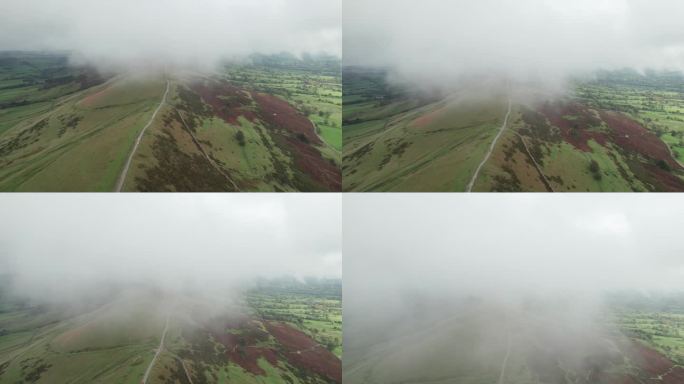英国峰区曼托徒步小径。乡间连绵起伏的山峦，无人机飞入云端