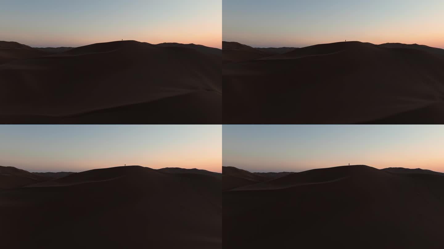 航拍黄昏新疆库木塔格沙漠的剪影