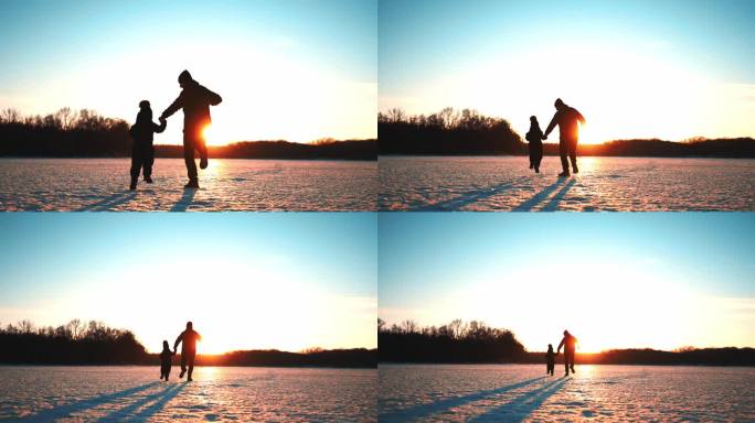无价的为人父母时刻。夕阳下，快乐的爸爸和小儿子在冬日公园里奔跑。冬天公园里美丽的日落。