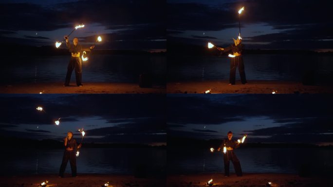 专业的马戏团女演员在夜晚的湖岸上耍耍燃烧的火炬