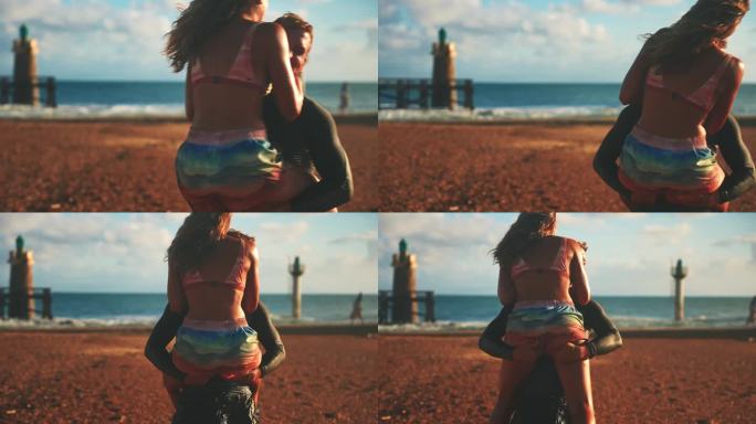一对无忧无虑的情侣在阳光明媚的夏日沙滩上拥抱