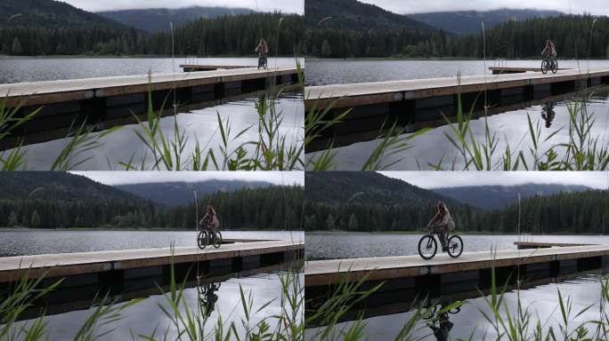 年轻女子沿着湖上的木码头骑自行车
