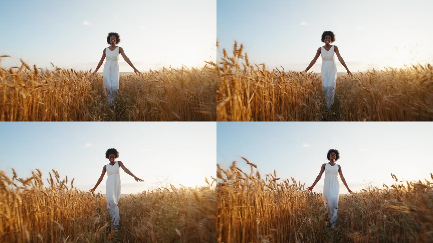 优雅的黑人妇女，留着一头白色的长发，穿着白色的连衣裙，穿过麦田，迎着风微笑着，在夏日的夕阳下散步，享