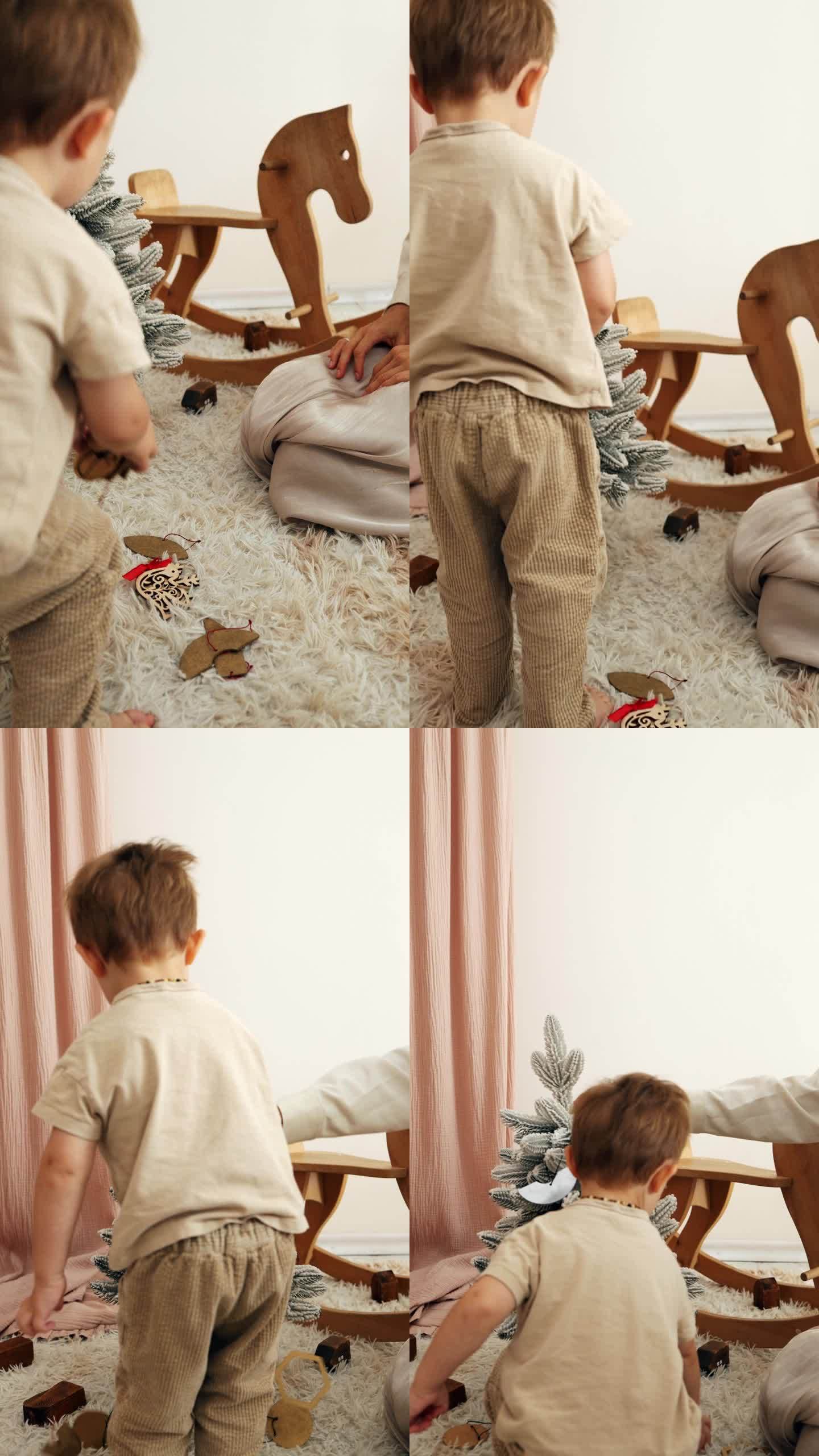 一个小男孩和他的妈妈在房间里装饰一棵小圣诞树，背景是一个玩具木马。垂直视频