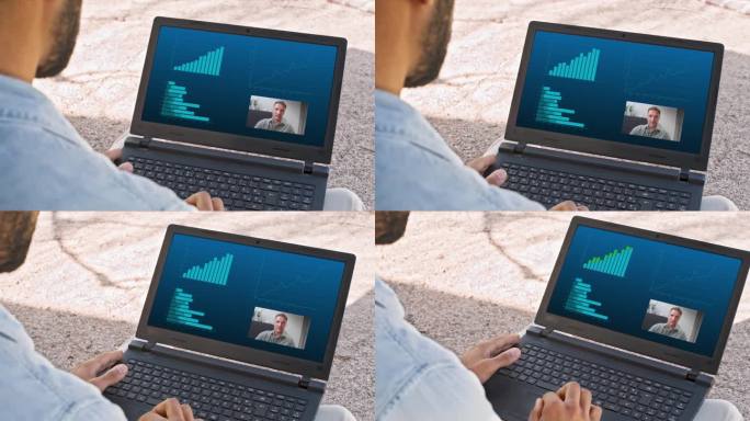 一个人坐在外面用笔记本电脑开视频会议